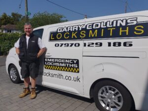 Garry Collins stood next to sign written locksmith van in Broadstairs wearing white t shirt wearing black body warmer